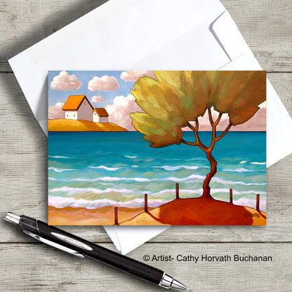 greeting card of a lone tree on a beech with an envelope and pen, greeting card by artist Cathy Horvath Buchanan,